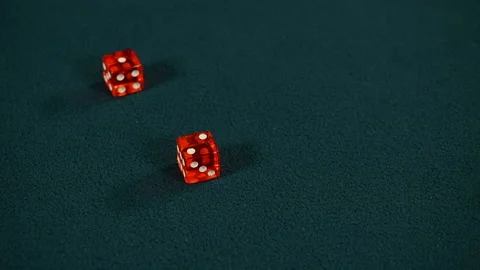 Two red dice roll two and one on green casino gaming table, Craps, Slow motion Stock Footage 221075946