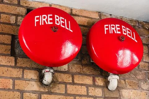 Two Red Fire Bells Mounted On Building Wall Stock Photos