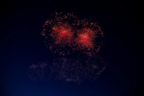 Two red firework balls with a bright red center hang against the background of Foto stock