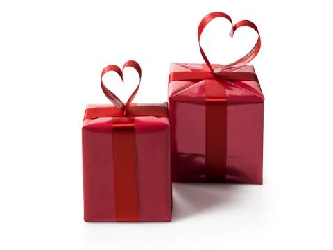Two red gift boxes with red hart shaped ribbon bow Stock Photos