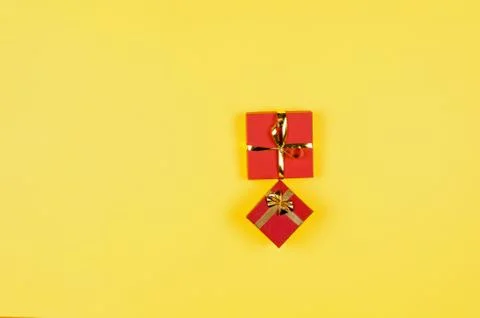 Two red gift boxes on yellow background. 写真素材