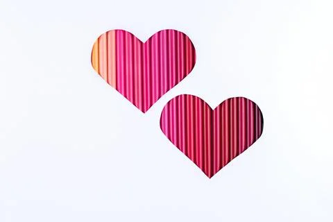 Two red gradient hearts made from pencils on white background, closeup, copy Foto stock