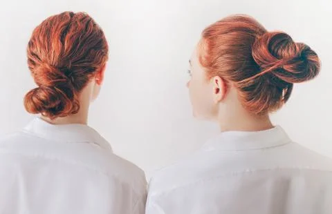 Two red-haired sisters stand isolated on a white background in shirts. Women Stock Photos