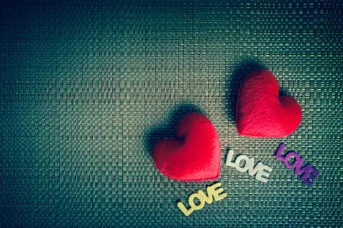 Two red heart and text "LOVE" on the texture background Stock Photos