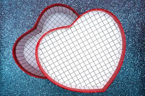 Two red heart boxes on blue glitter background Stock Photos