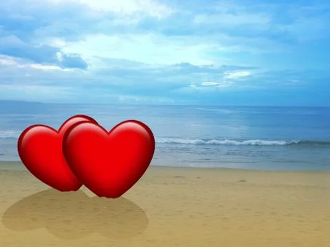 Two red hearts on the beach during sunset Stock Photos