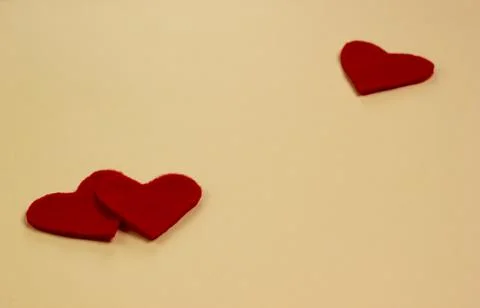 Two red hearts on a beige background. The concept of Valentine's day Stock Photos