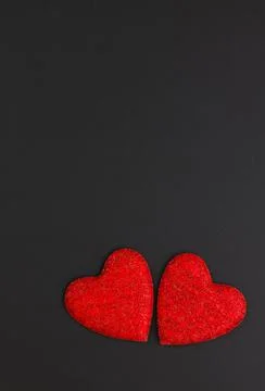 Two red hearts on a black background. Festive background. Minimalism. Copy sp Stock Photos