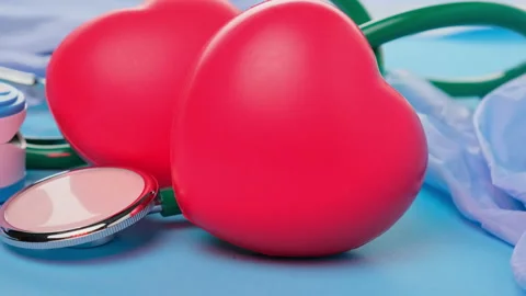Two red hearts on blue background, health and kindness concept, close up Stock Footage 147706756