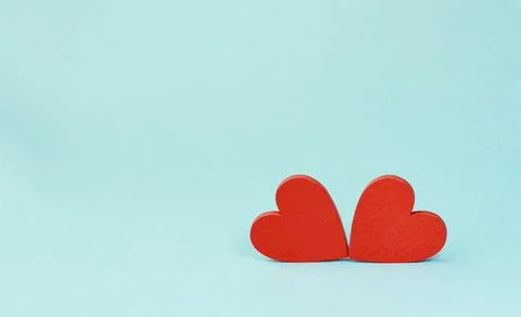 Two red hearts on a blue background, a banner with space for a copy. Фото