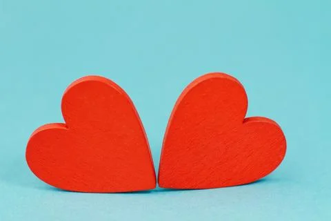Two red hearts on a blue background, the concept of a valentine's day. Stock Photos
