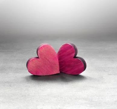 Two red hearts on a gray surface and gray background Stock Photos
