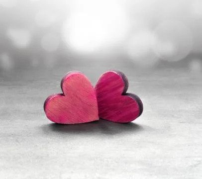 Two red hearts on a gray surface and gray background Stock Photos