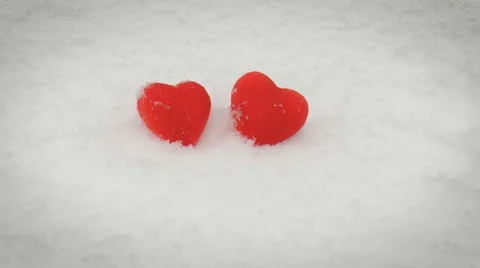 Two red hearts lying on snow Stock Footage 68188660