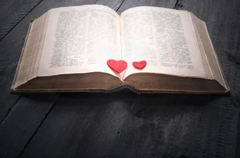 Two red hearts on an open book Stock Photos
