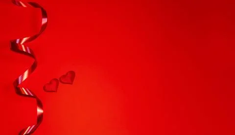 Two red hearts on a red background with waves of red ribbon. Horizontal, plac Stock Photos