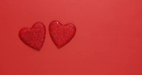 Two red hearts on a red background. Copy space. Festive background. Backgroun Stock-Fotos