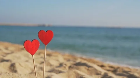 Two red hearts in the sand against the background of sea waves with copy space. Stock-Footage 122298520