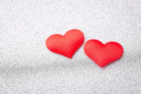 Two red hearts on silver background Stock Photos