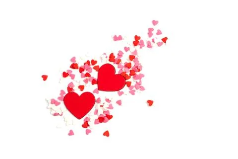 Two red hearts surrounded by small hearts of different colors on a light Stock Photos
