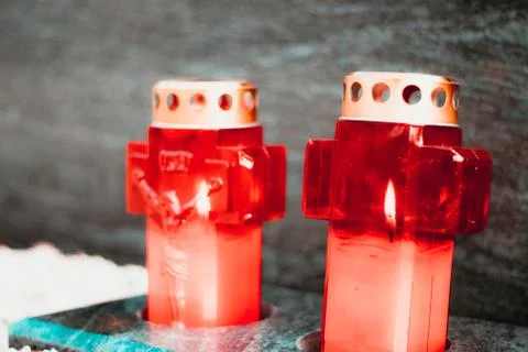 Two red lit candles in front of a marble grave , public cemetary. Stock Photos