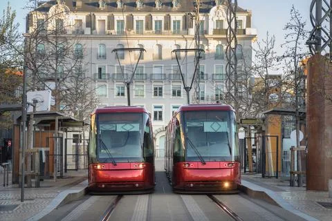 Two red modern rubber-tyred trams in Clermont-Ferrand, France Foto stock