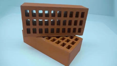 Two red new facing bricks, as sample of brick factory products at an exhibition Video stock 259865924