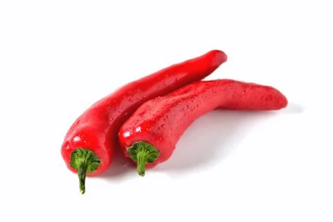 Two red peppers on white background with drops of water, isolate Stock Photos