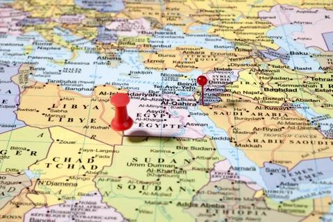 Two red push pins on world map Stock Photos