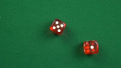 Two red roll dices and stops on the table with 1 and 5 in slow motion. Stock Footage 209143727