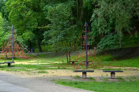 Two red rope net pyramids for kids on a playground in a green park area Stock Photos