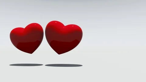 Two red rotating hearts on a white background Stock Footage 101589279