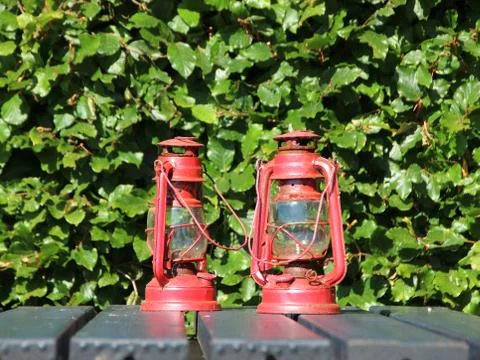 Two Red Rusty Lanterns on Black Table Foto stock