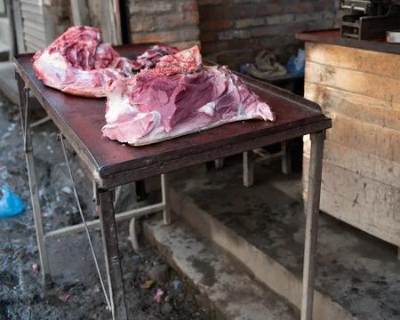 Two red slabs of raw meat on a local street in Varanasi, India Stock Photos
