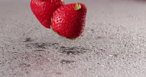 Two Red Strawberries Fall on Wet Surface in Slowmotion Video stock 138541845