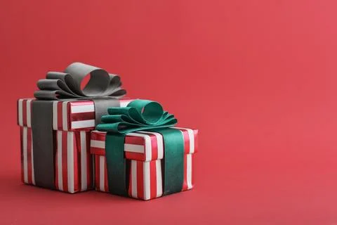 Two red striped gift box with green and grey ribbon Stock Photos