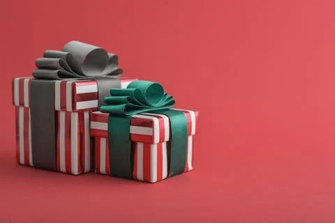 Two red striped gift box with green and grey ribbon Stock Photos