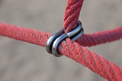 Two red thick ropes are attached with metal ring Foto stock
