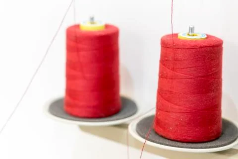 Two red thread coils. Threads for industrial sewing machines Stock Photos