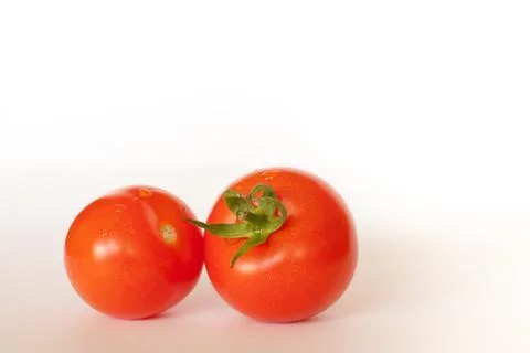 Two red tomatoes isolated on white background Stock Photos