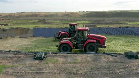 Two Red Tractors Tamp Silage in the Silo Trench Stock Footage 220512938