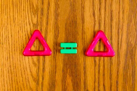 Two red triangles and the equals sign Stock Photos