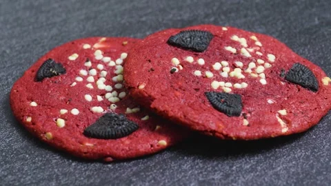 Two red velvet cookies with chunks of sandwich cookies and white chocolate chips Stock Footage 314211537