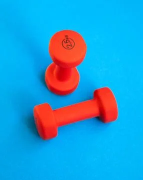 Two red weights 2.5 kg on the blue background. Stock Photos