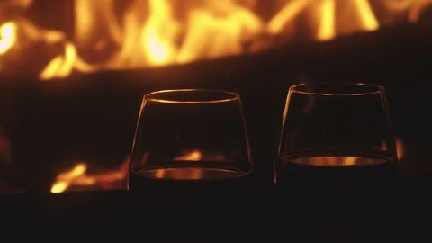 Two red wine glass in front of fireplace Stock Footage 123139852