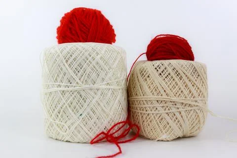 Two red yarn on the top of two cream yarn isolated on white background Stock Photos