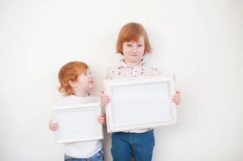 Two redhead children with frames Stock Photos