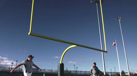 Two referees wave their arms back and forth after a missed field goal Stock Footage 33871053