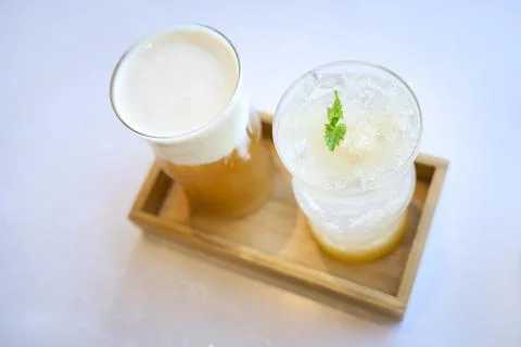 Two refreshing cold drinks with ice and mint on wooden tray Stock Photos