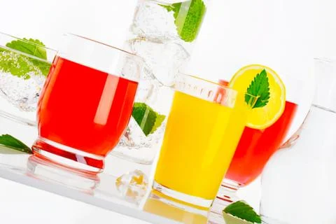 Two refreshing colored drinks with ice and lemon Stock Photos